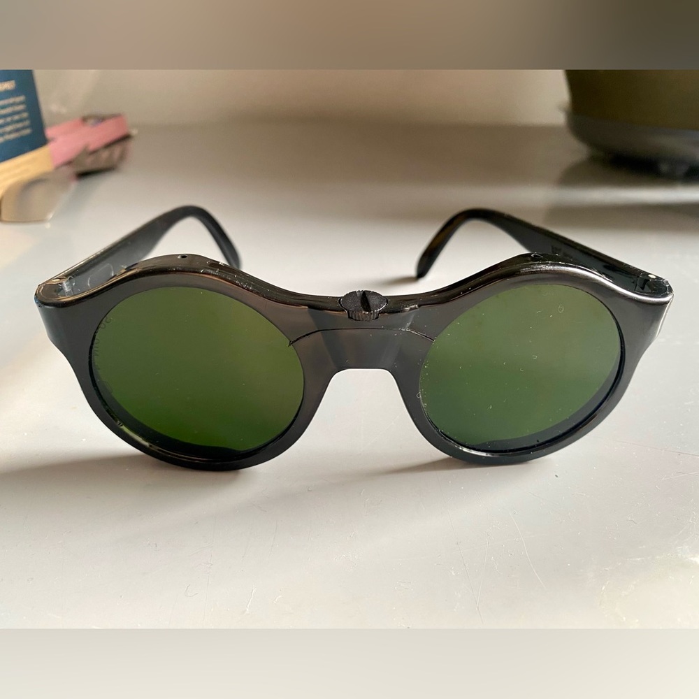 Made in France, round black nylon frames with removable green glass lenses.